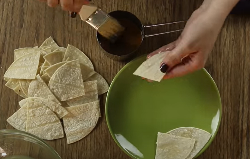 Brushing tortillas with bacon fat